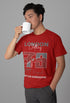 Person wearing a red t-shirt with text and holding a white mug on a gray background