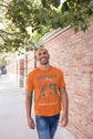 Man wearing an orange t-shirt with &