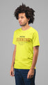 Man wearing a bright yellow t-shirt with text on a gray background