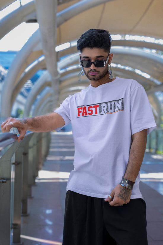 Man wearing a white t-shirt with &