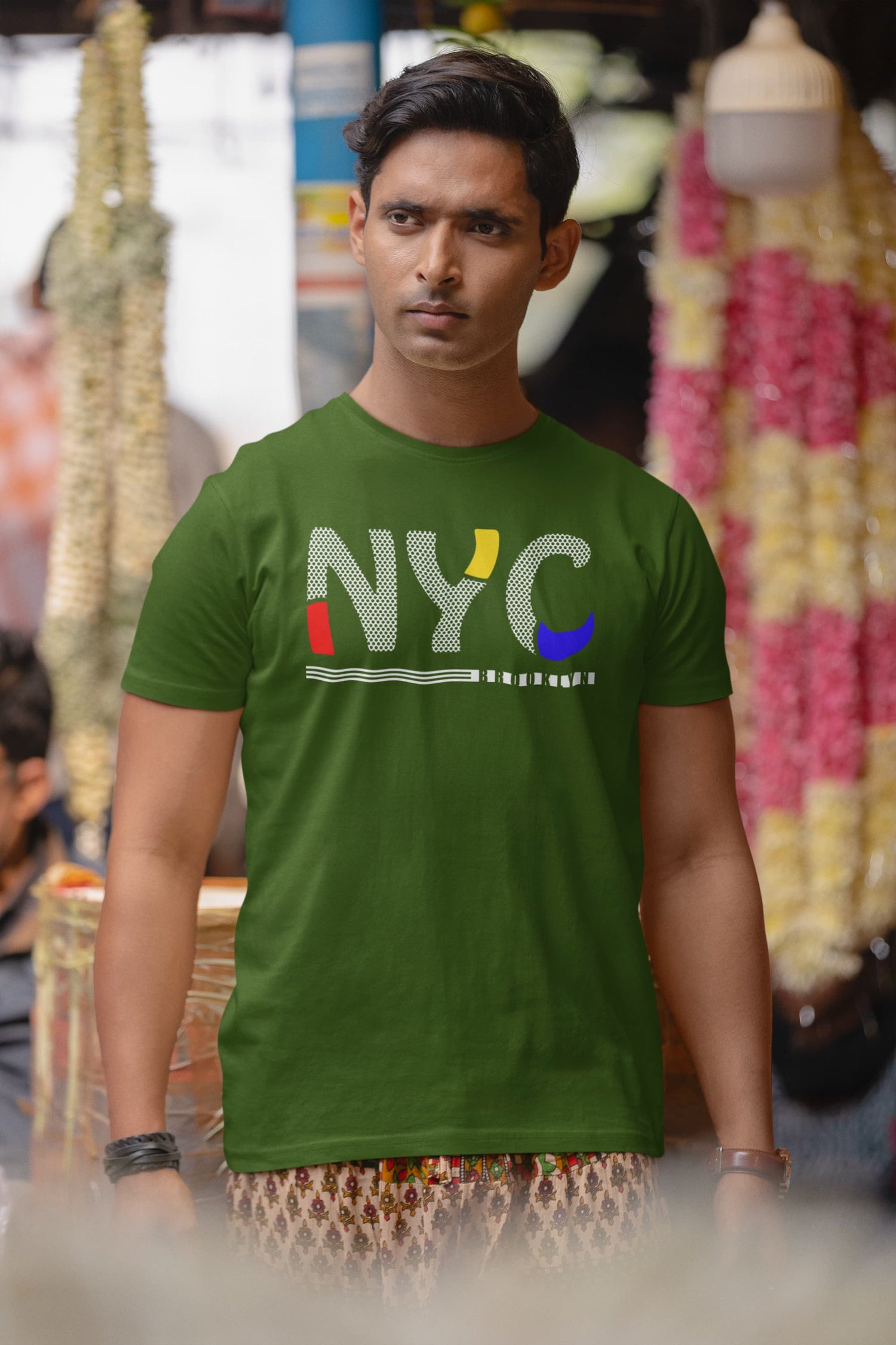 Man wearing a green t-shirt with &
