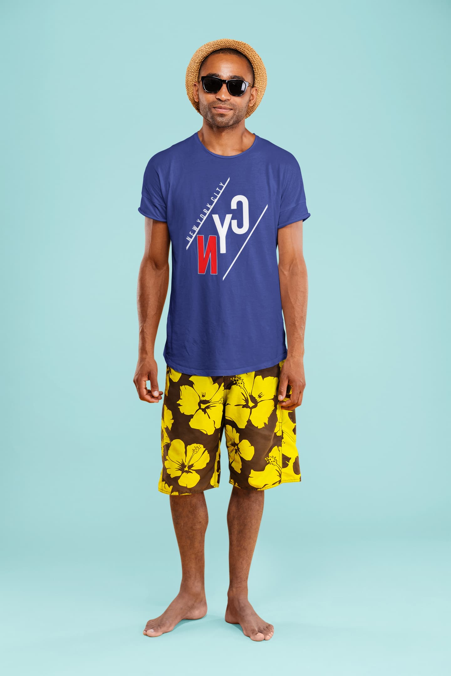 Man wearing a blue t-shirt with a logo and yellow floral shorts on a light blue background