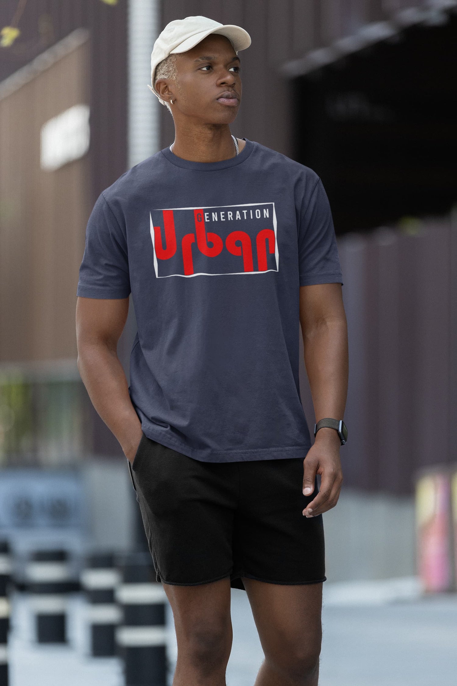 Person wearing a blue t-shirt with a logo, standing outdoors.