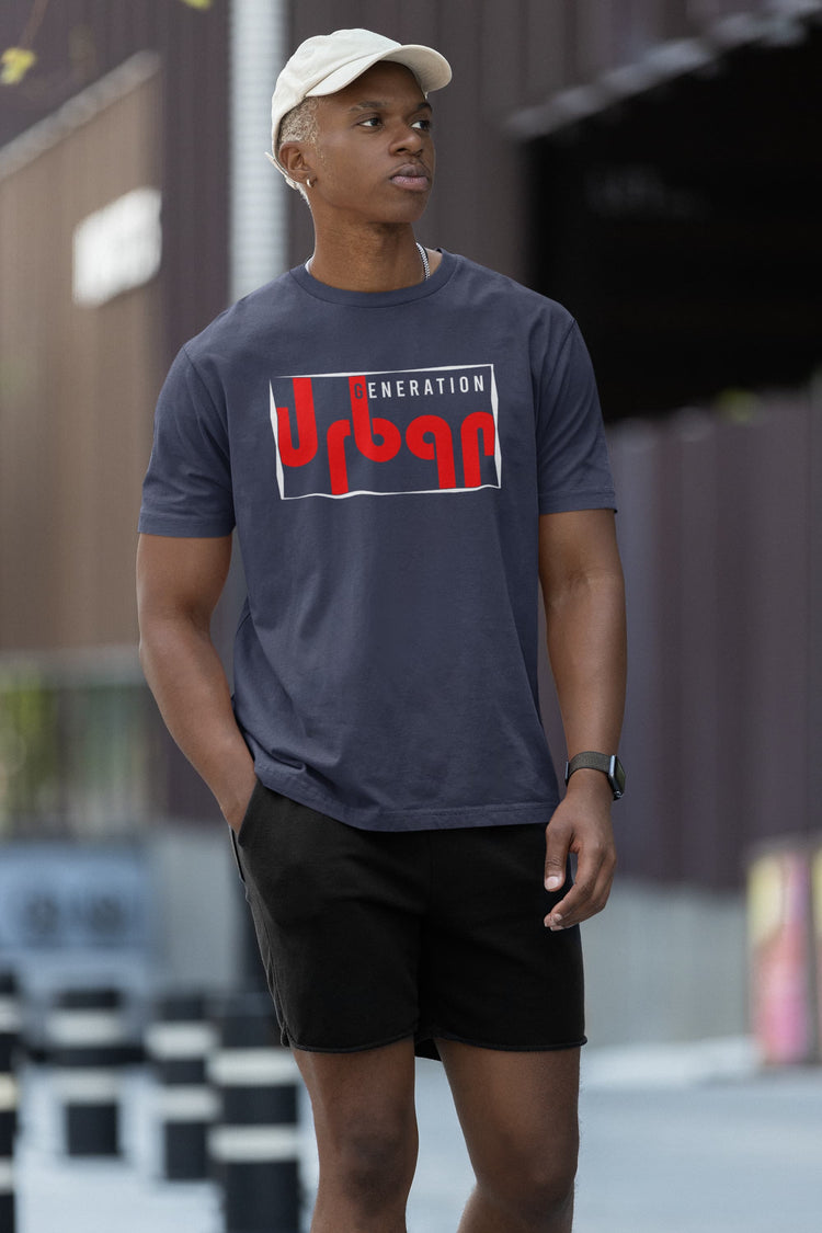 Person wearing a blue t-shirt with a logo, standing outdoors.