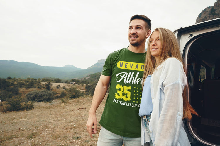 Man and woman standing next to an open car door in a scenic outdoor setting.
