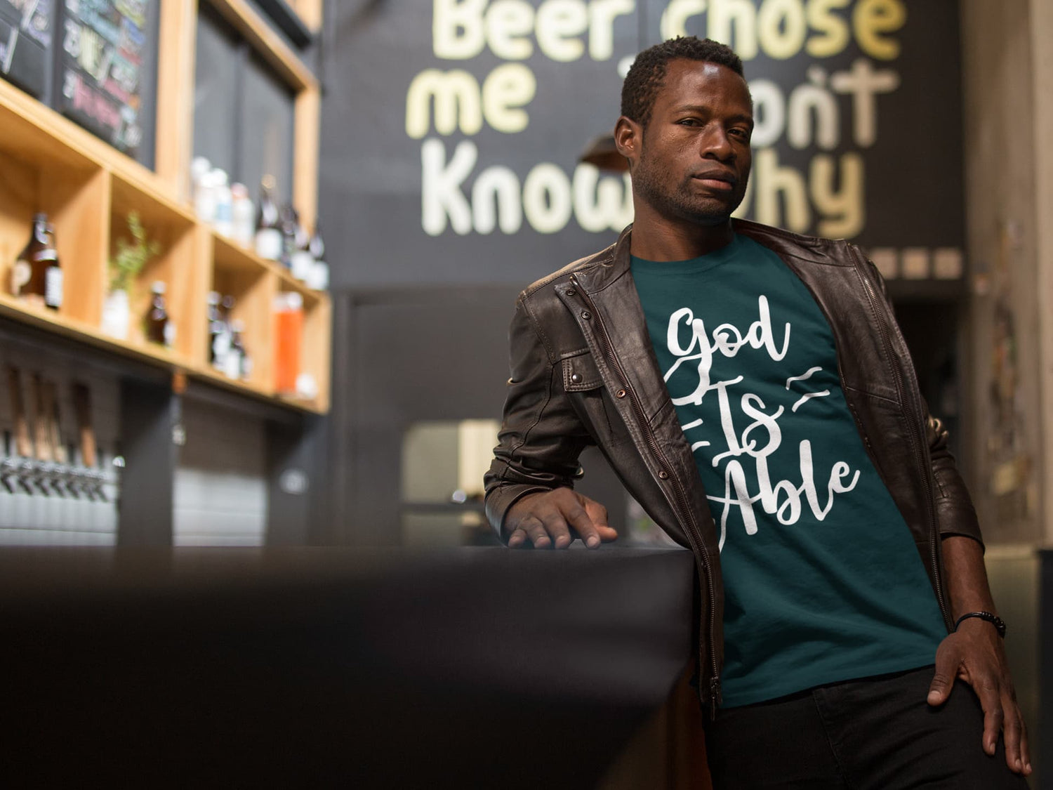 Man wearing a teal t-shirt with &