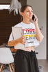 Woman talking on a phone and holding a notebook in a home setting