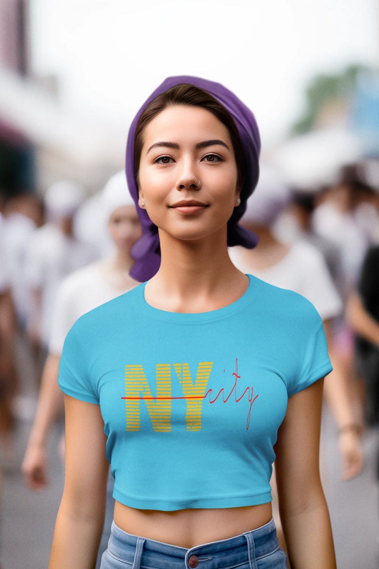 Woman wearing a blue t-shirt with colorful text in an urban setting