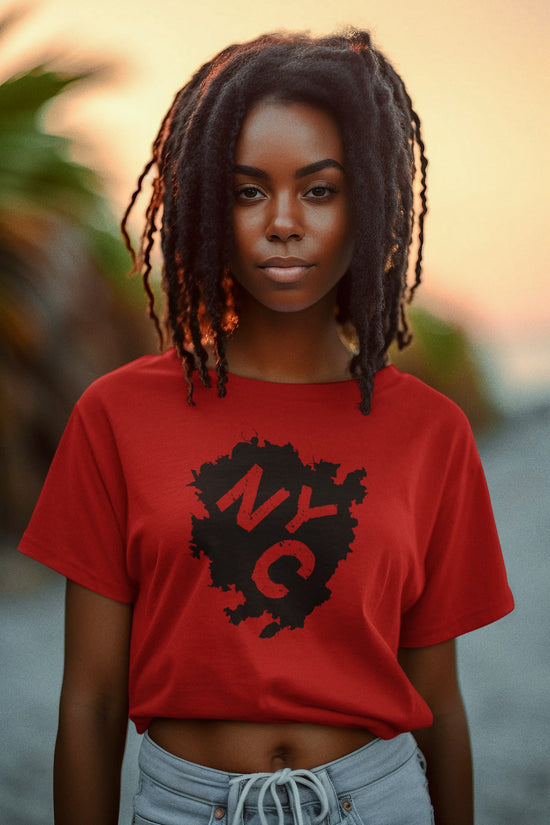 Person wearing a red t-shirt with a black logo, standing outdoors with a blurred natural background
