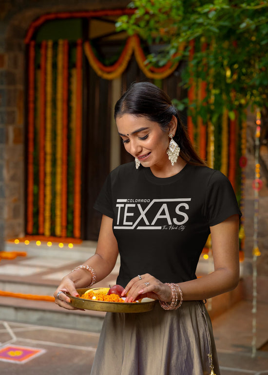 Woman holding a tray of food in a decorated outdoor setting
