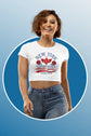 Woman wearing a white t-shirt with text and graphics on a blue background