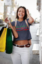 Woman in a casual outfit with shopping bags on a city street