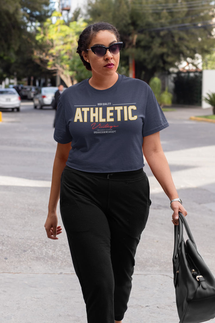 Woman walking outdoors wearing a dark blue t-shirt with &
