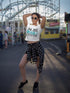 Woman posing in a white crop top with &