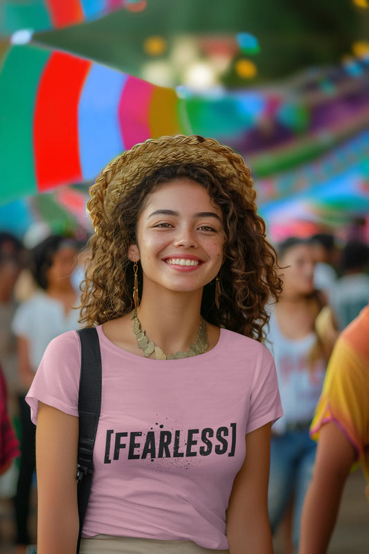 Woman wearing a pink 'FEARLESS' t-shirt in a colorful outdoor setting