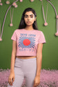 Woman wearing a pink t-shirt with &