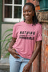 Woman wearing a pink t-shirt with &