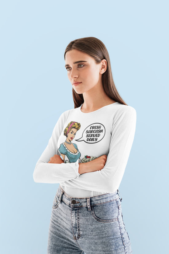 Woman wearing a white long-sleeve shirt with a graphic design on a light blue background