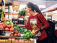Woman shopping at a farmers market with produce in the background