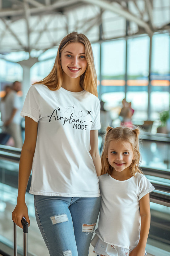 Woman and child in an airport wearing matching &