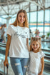 Woman and child in an airport wearing matching &