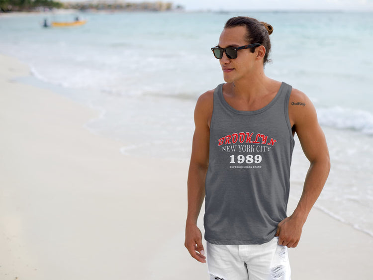 Man wearing a tank top with text on a beach