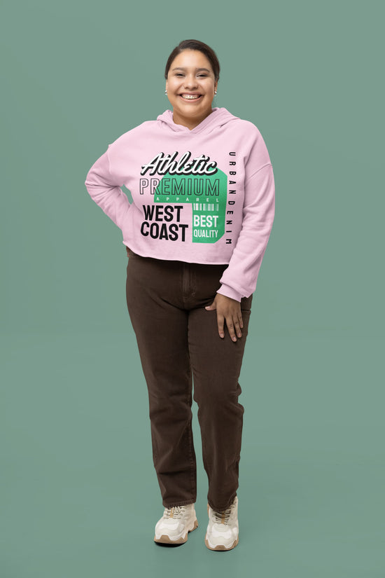 Person wearing a pink hoodie with text on a green background