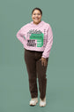 Person wearing a pink hoodie with text on a green background