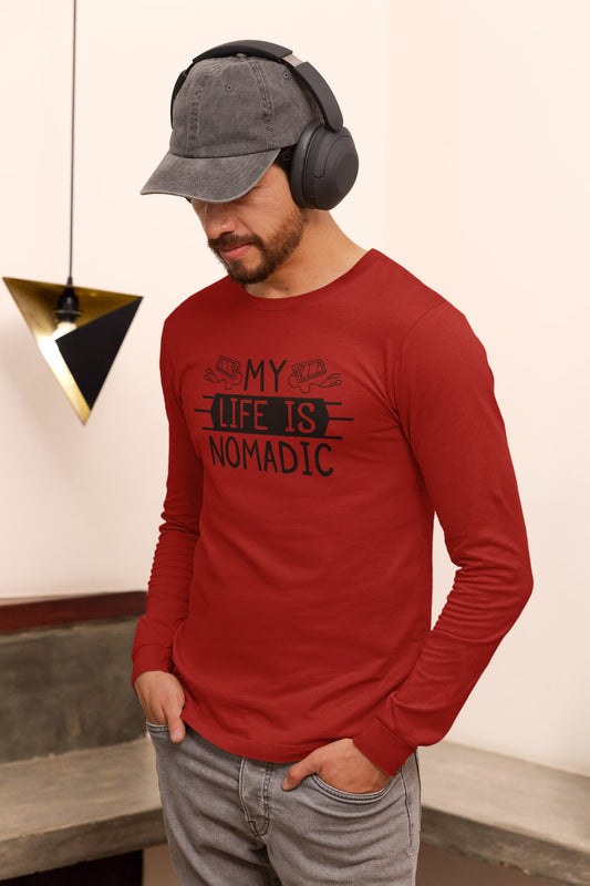 Man wearing a red long-sleeve shirt with 'My Life is Nomadic' text, gray cap, and headphones indoors.