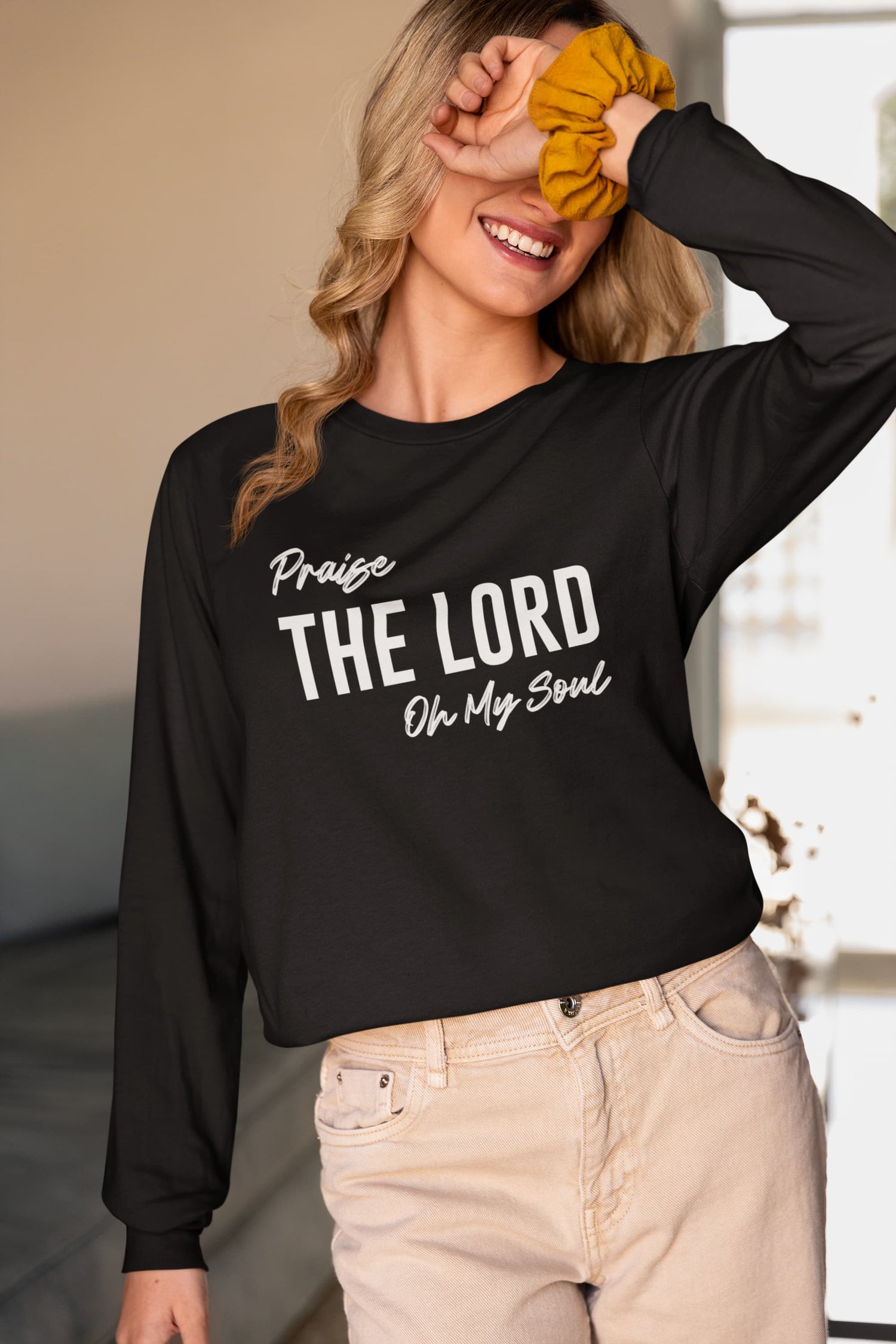 Woman wearing a black sweatshirt with &