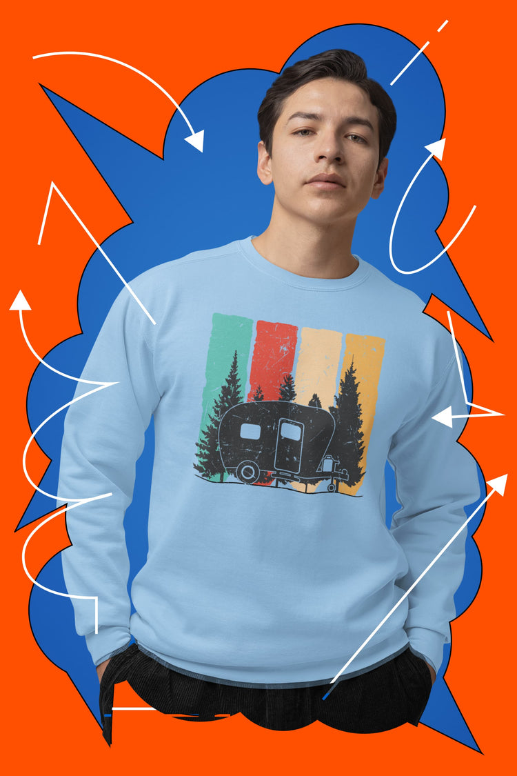 Person wearing a blue sweatshirt with a camper design against an orange and blue abstract background