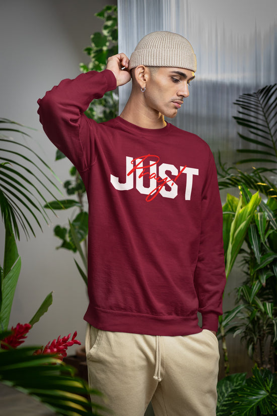 Person wearing a maroon sweatshirt with &