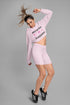 Woman wearing a pink outfit with &