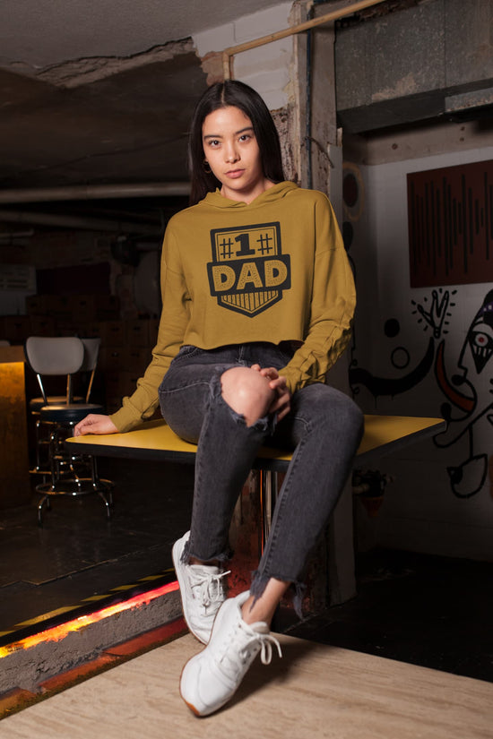Person wearing a mustard yellow hoodie with &