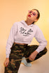 Woman wearing a white hoodie with &