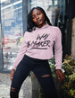 Person wearing a pink hoodie with &