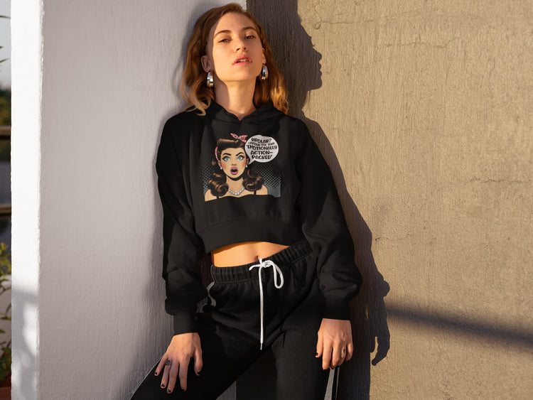 Woman wearing a black hoodie with graphic design against a beige wall