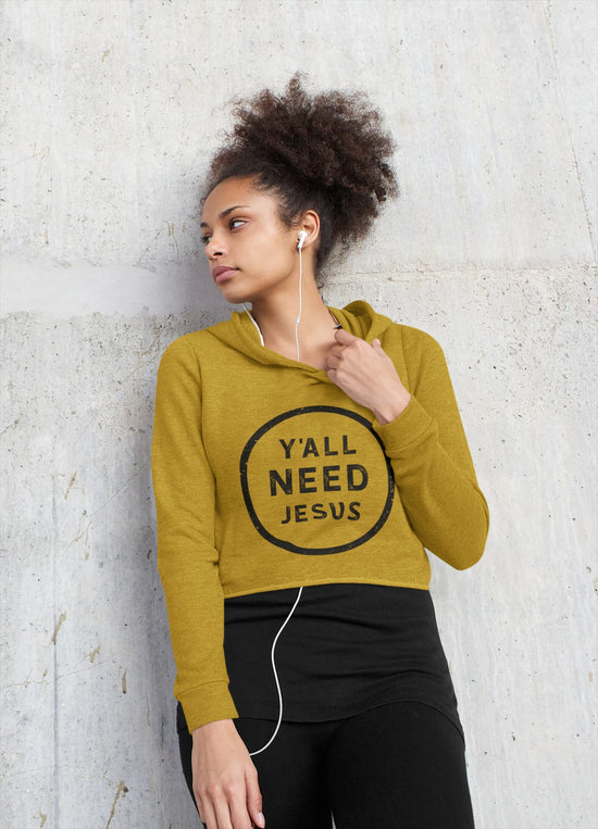 Woman wearing a mustard yellow hoodie with &