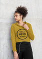 Woman wearing a mustard yellow hoodie with &