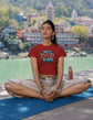 Person meditating on a yoga mat with a scenic background