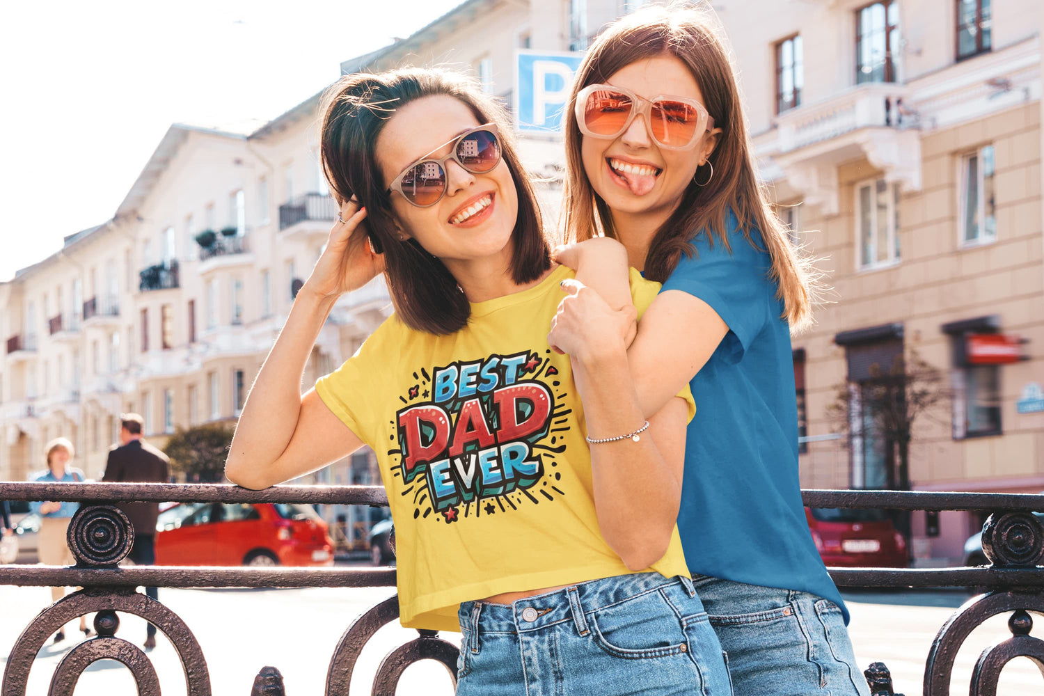 Two women posing outdoors with one wearing a &