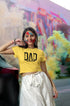 Woman wearing a yellow t-shirt with &