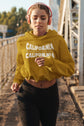 Woman wearing a yellow &
