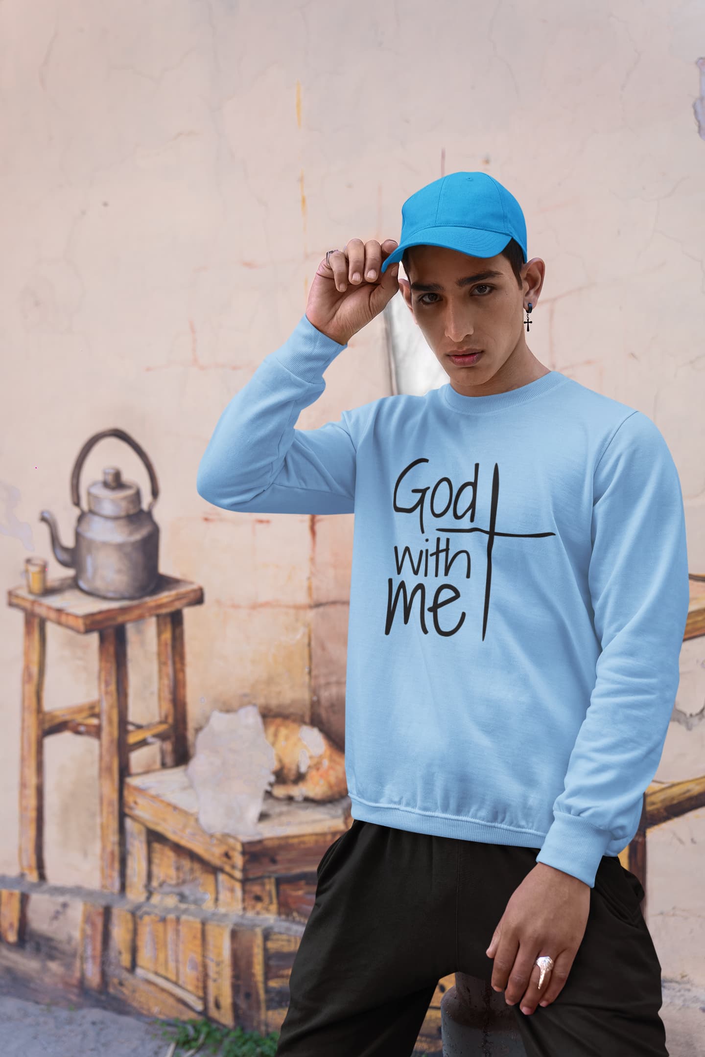 Person wearing a light blue sweatshirt with &
