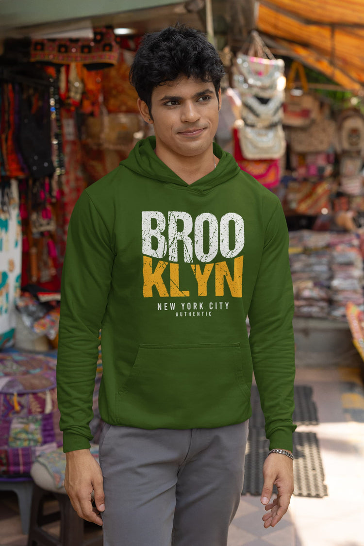Man wearing a green hoodie with &