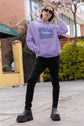 Person wearing a purple hoodie with &