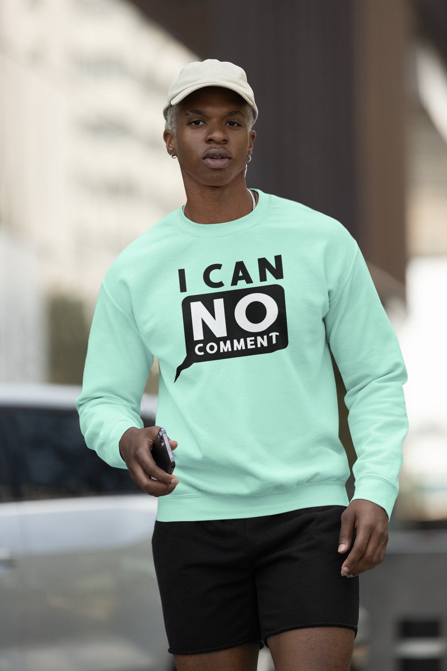 Person wearing a light green sweatshirt with &