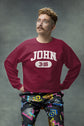 Person wearing a maroon sweatshirt with &