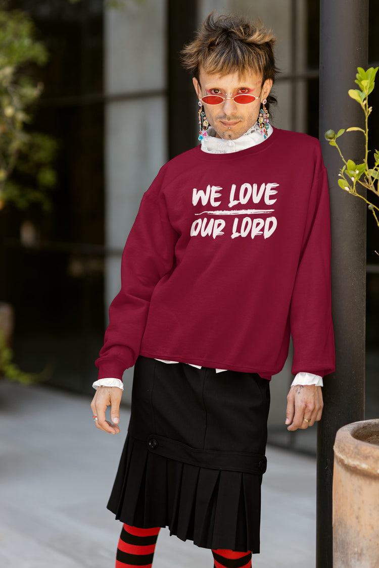 Person wearing a red sweatshirt with text, standing outdoors.