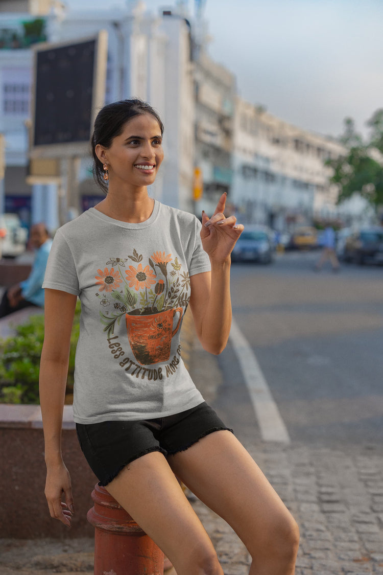 Woman wearing a graphic t-shirt sitting on a street light pole with a cityscape background